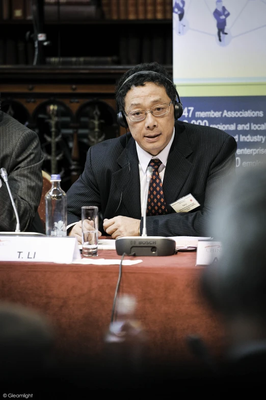 two men at a table talking to each other