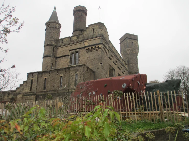 a large building sitting next to a tall metal fence