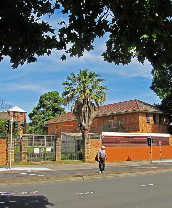 an old brick building with two small trees