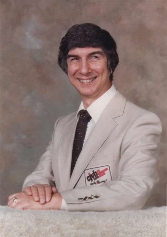 an older portrait of a man in a white suit