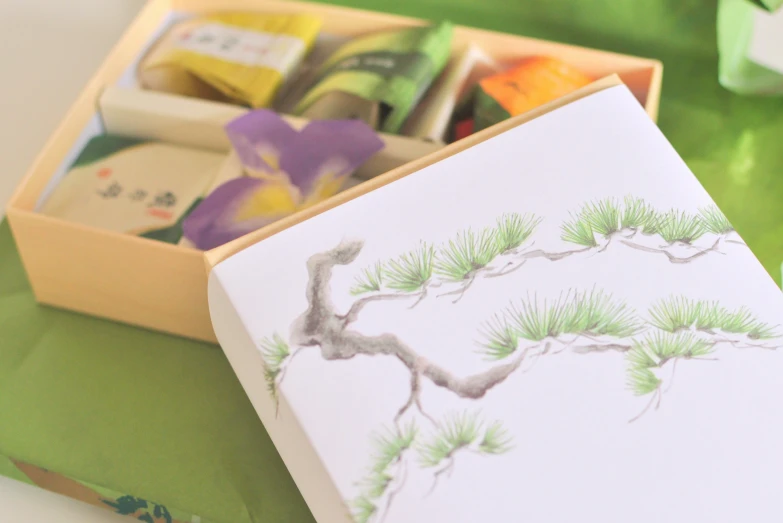 a card with pine nches inside the box