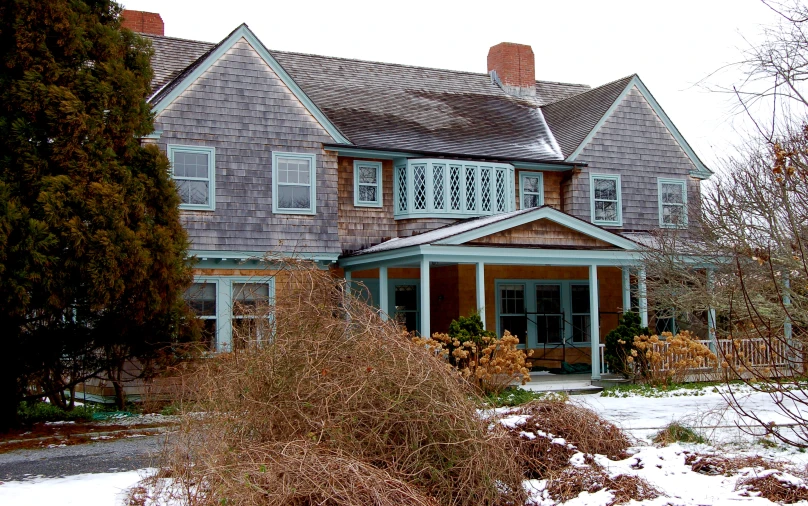 a large house is shown in wintertime