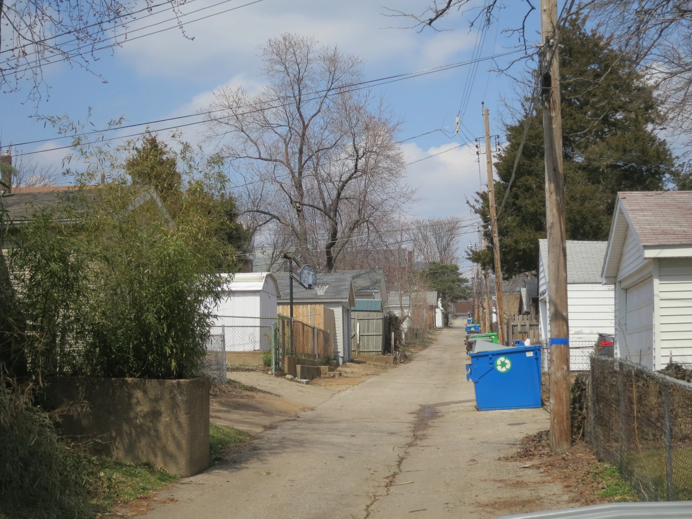 a narrow street in a neighborhood with several houses