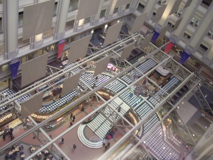 an overhead view shows a lobby area with many steps and people walking