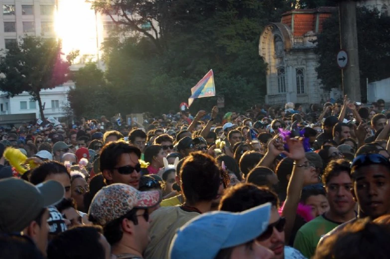 many people with head bands standing in front of building and trees