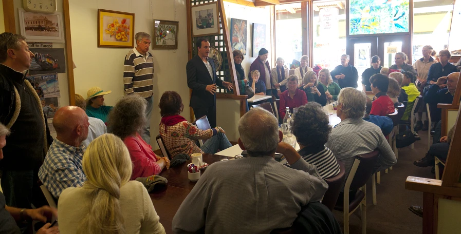 people in a room with pictures and a speaker