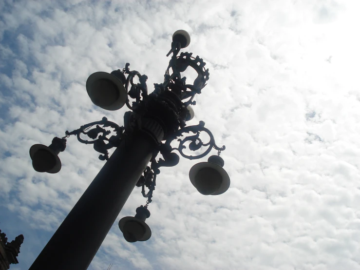 a tall street lamp on a sunny day