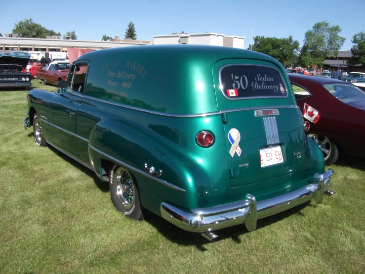 a green truck with a red sign on the rear