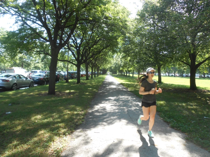 the woman running in the park is wearing a hat