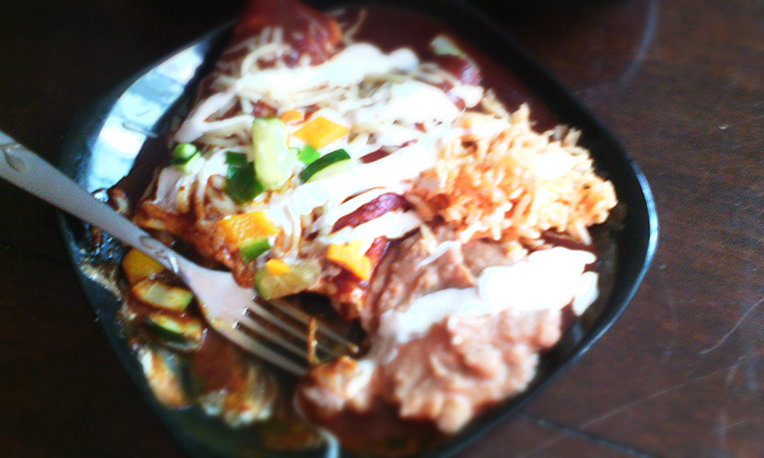 a salad plate has meat, veggies and a fork on it