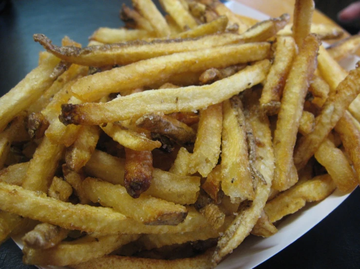 french fries on a paper plate on a table