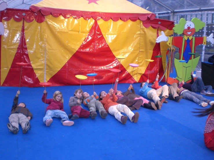 people are on the floor while an instructor directs children