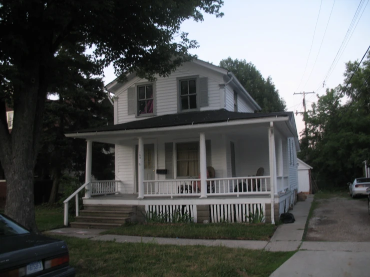 a white house with white balust and columns