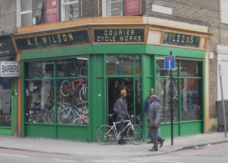 the bike shop has two customers standing outside