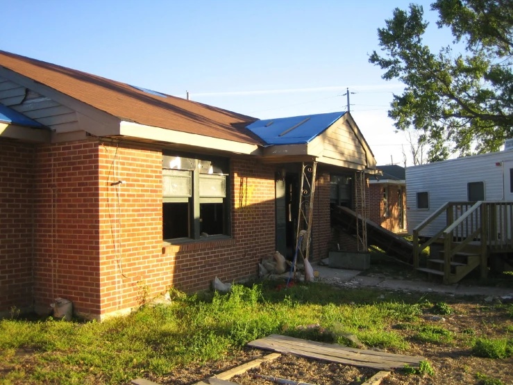 the building has boarded down and the blue metal roof