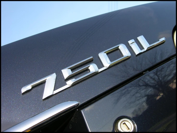 the back end of a black car with an emblem