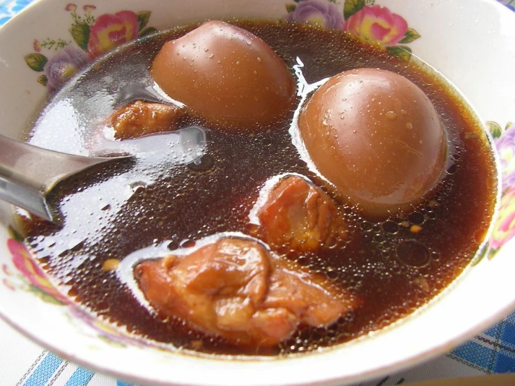 three peeled eggs are placed in a bowl