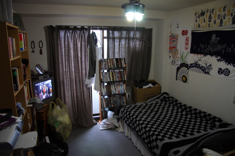 a bedroom with lots of clutter and a lot of windows