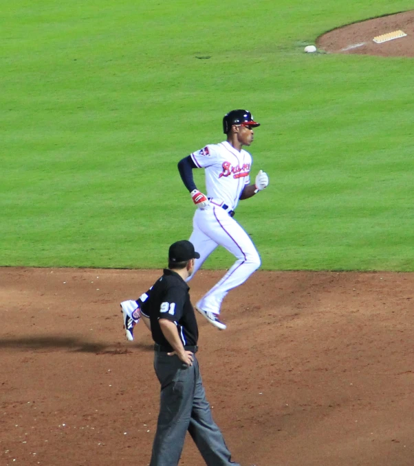 a man with a baseball bat and a umpire behind him