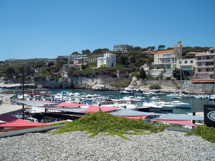 the bay where many boats are docked near a hill