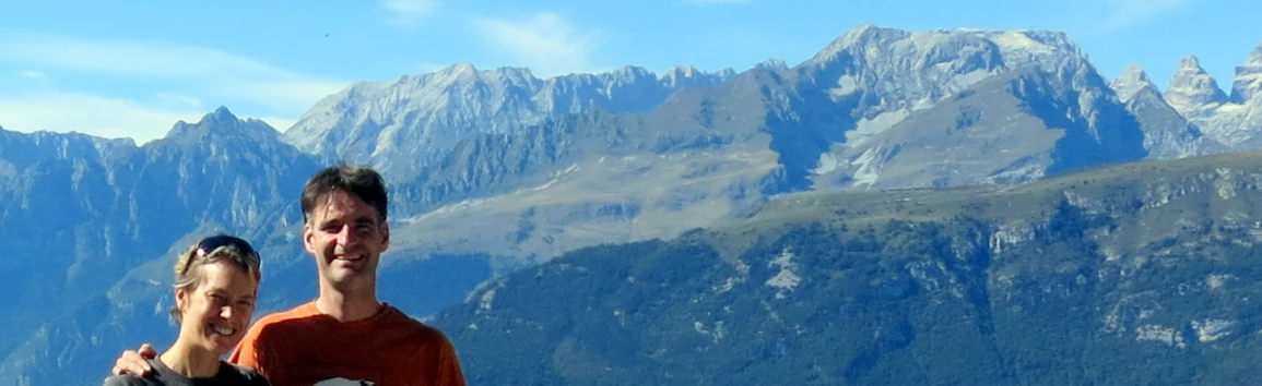 man and woman with sunglasses on looking at the mountain