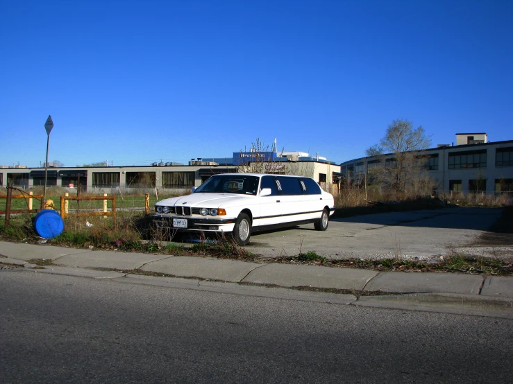 a white suv is parked near a fence