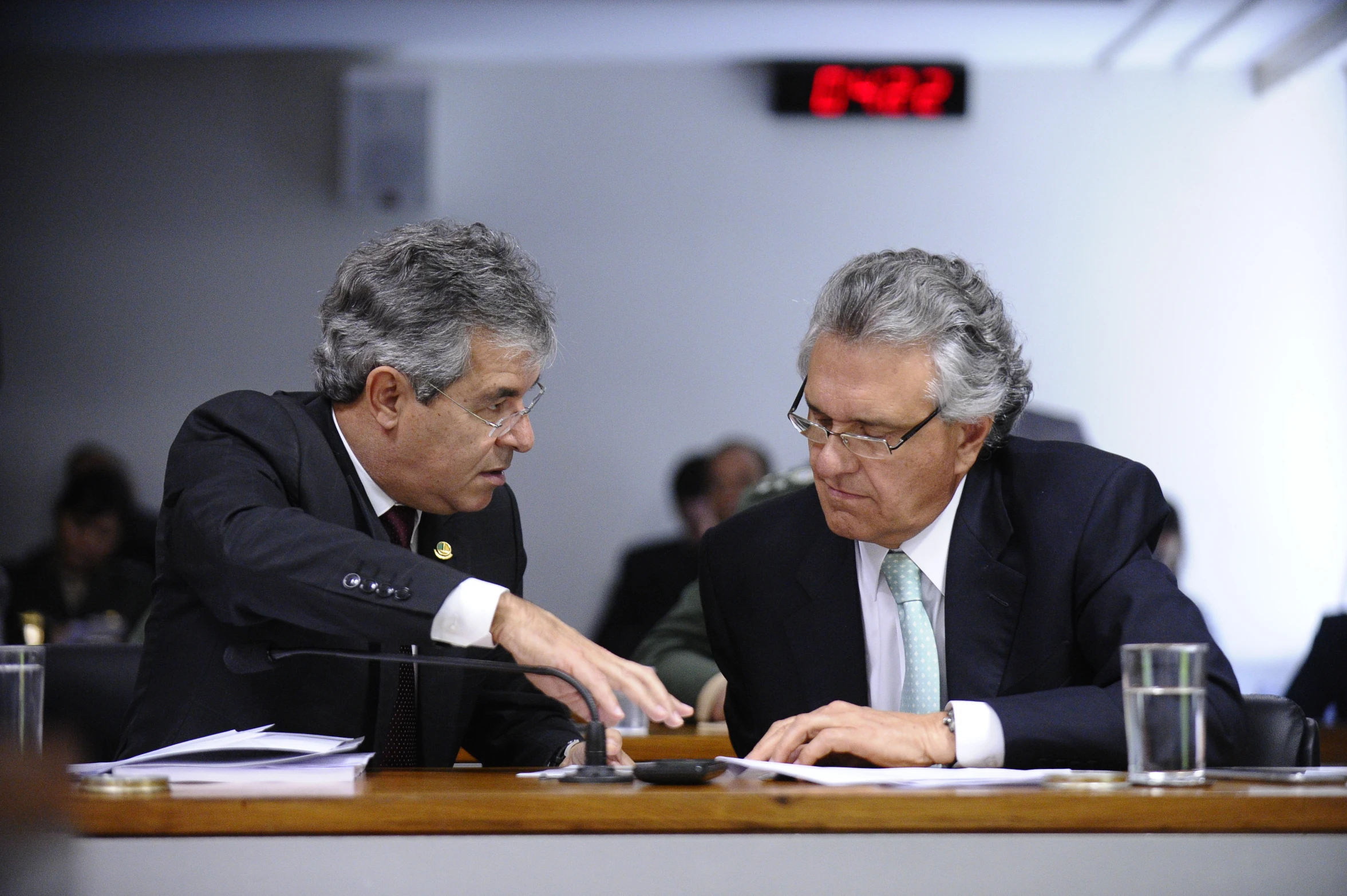 two people sitting at a table discussing soing