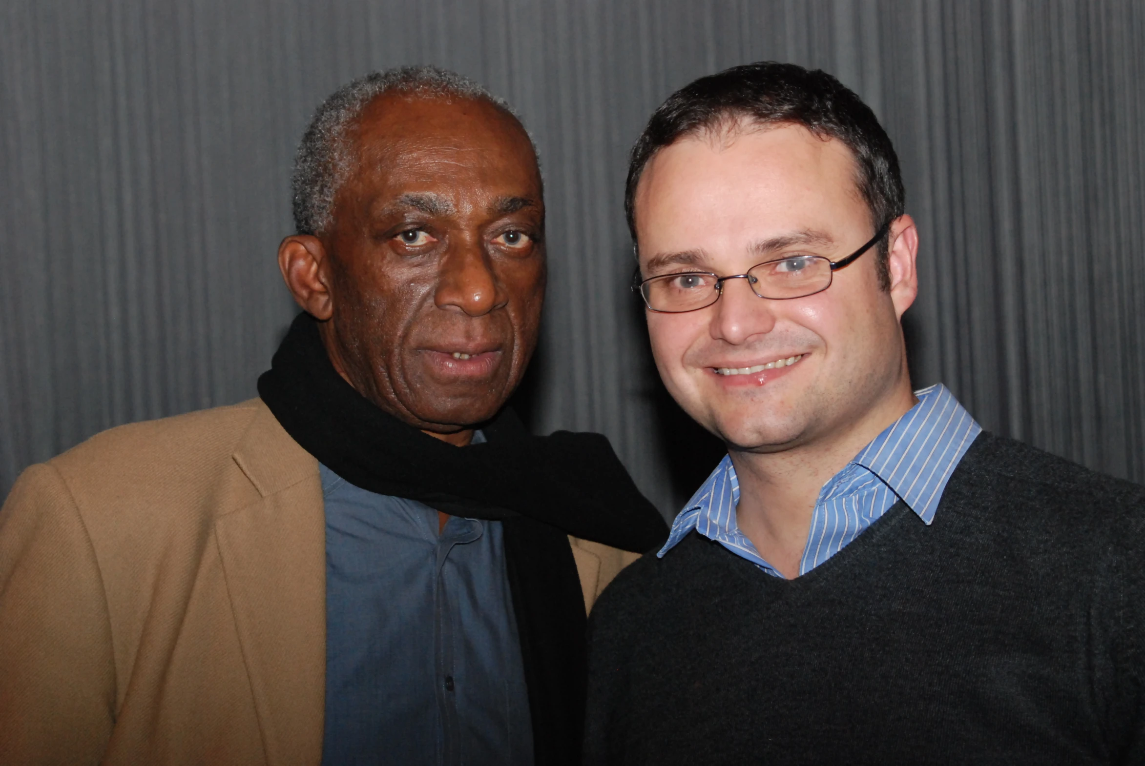 two old men are posing together at an event