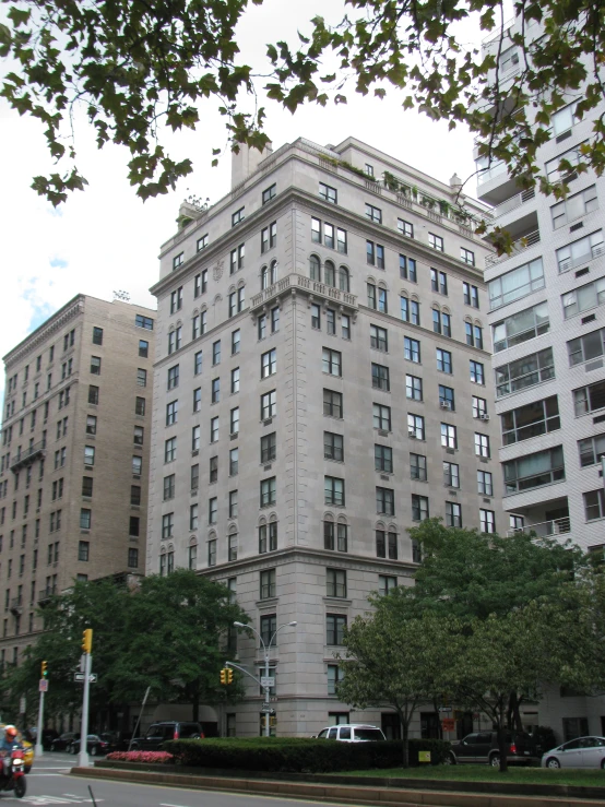 large white buildings with many windows and cars parked near one another