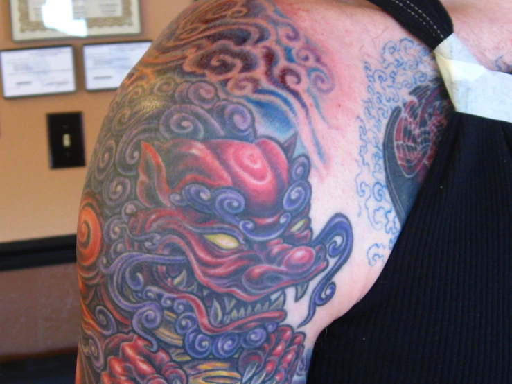 a close up of a person with tattoos on his arm