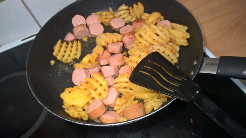 a set with ham and waffles cooking on top of it