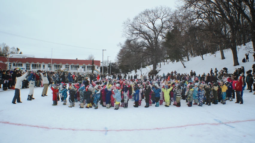 a crowd of people standing on top of a snow covered slope