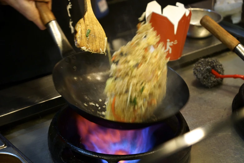 food is being cooked in a large pot on the stove