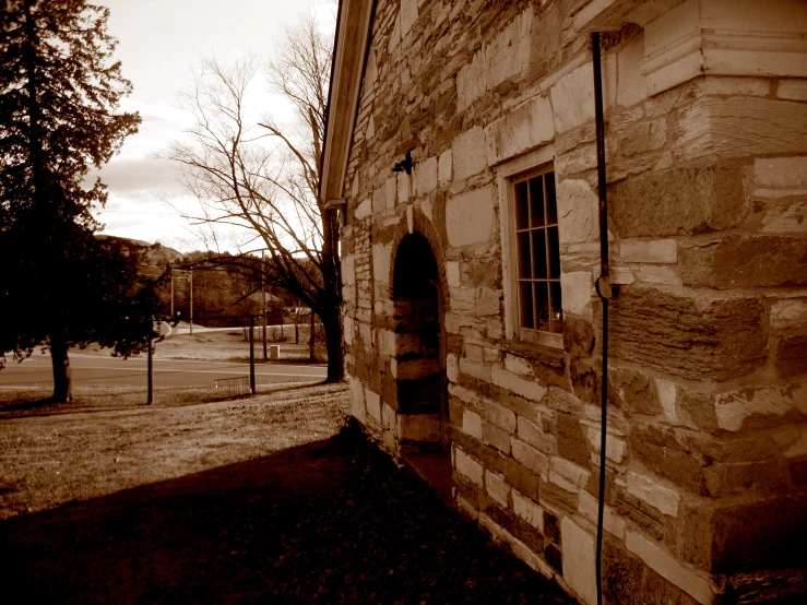 an old brick building stands out in the black and white picture