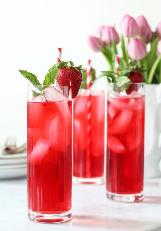 a strawberry cocktail, one with strawberries in it, on the table