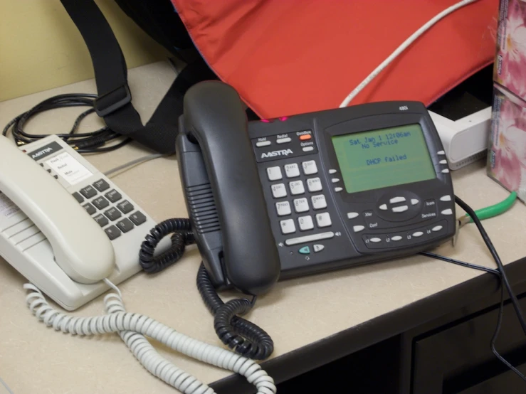 an old cell phone and a telephone cord attached to it