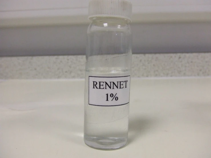 a small clear bottle filled with urine sits on a white surface