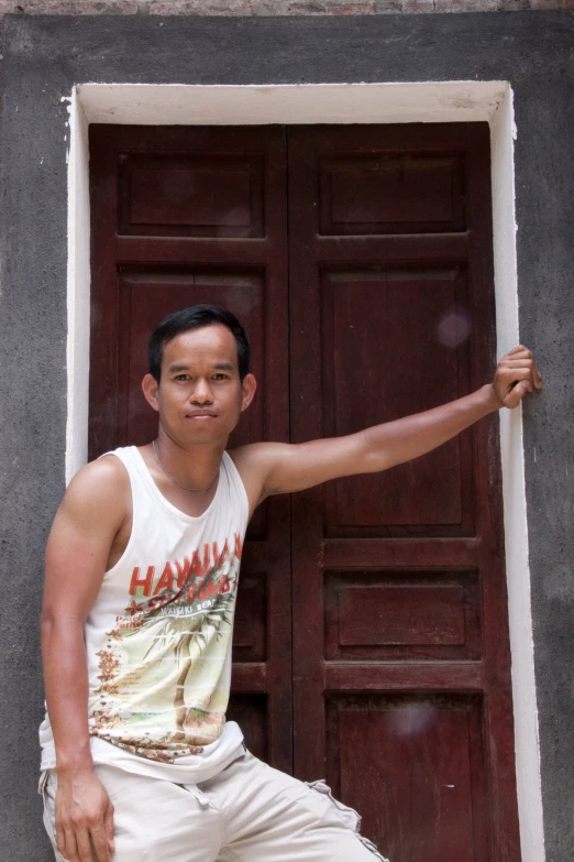 a man leaning on the wall with his arms open