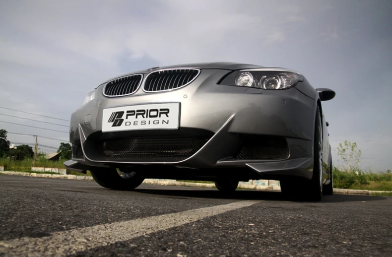 a picture of a silver bmw coupe parked on the road