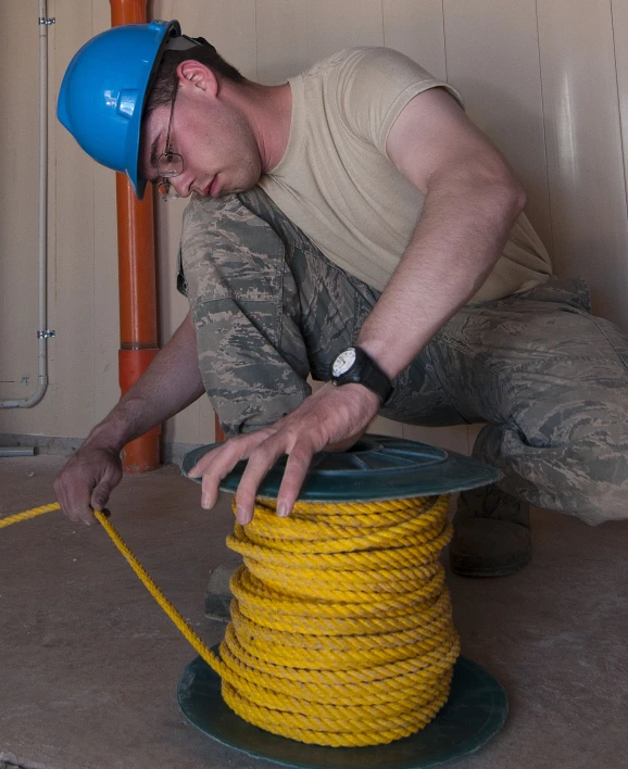 a man is working on the rope with safety equipment