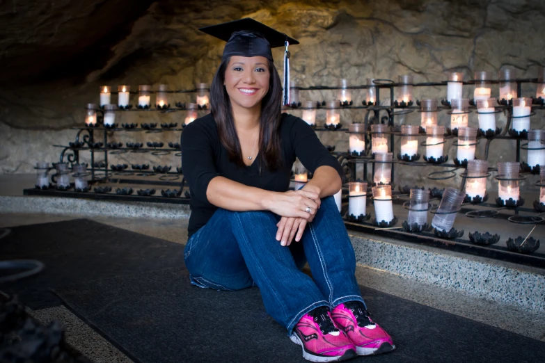 a  sitting on a curb in front of candles