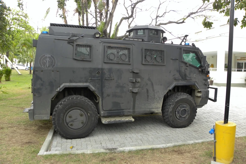 a grey armored vehicle parked in a lot