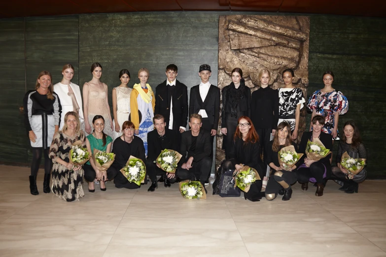 a group of people standing and sitting together