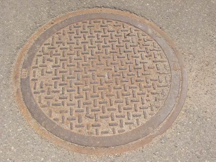 the street drain cover has been shaped into a round maze