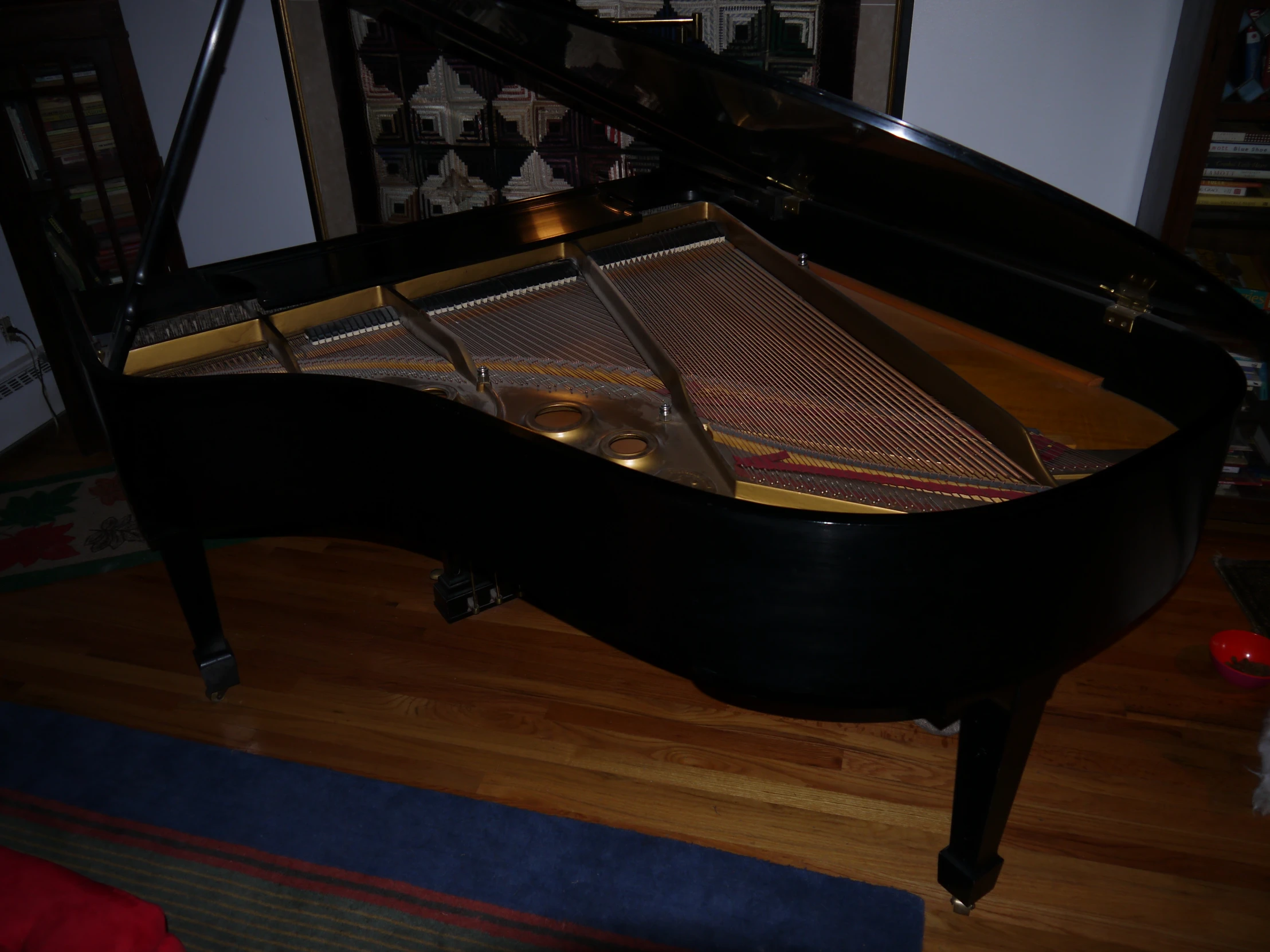 a piano sitting on the floor inside of a room