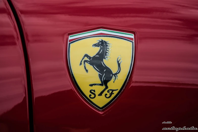 a ferrari logo is shown on the hood of a red car