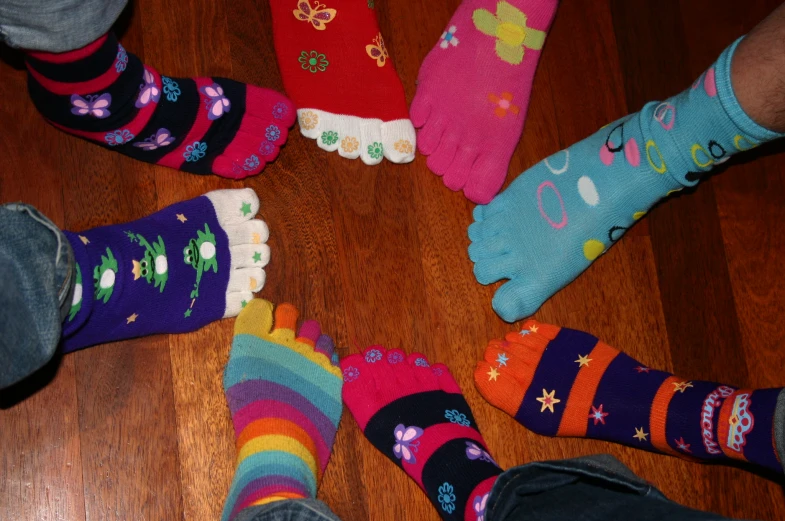 several people wearing colorful socks and socks in circle