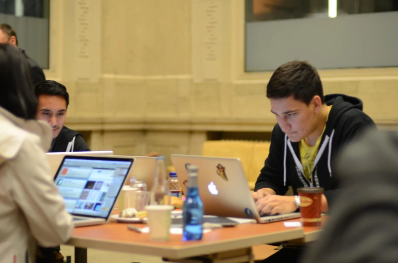 a young man working on his laptop at the desk