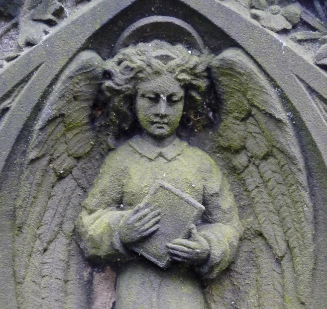 an angel statue in front of a stone building