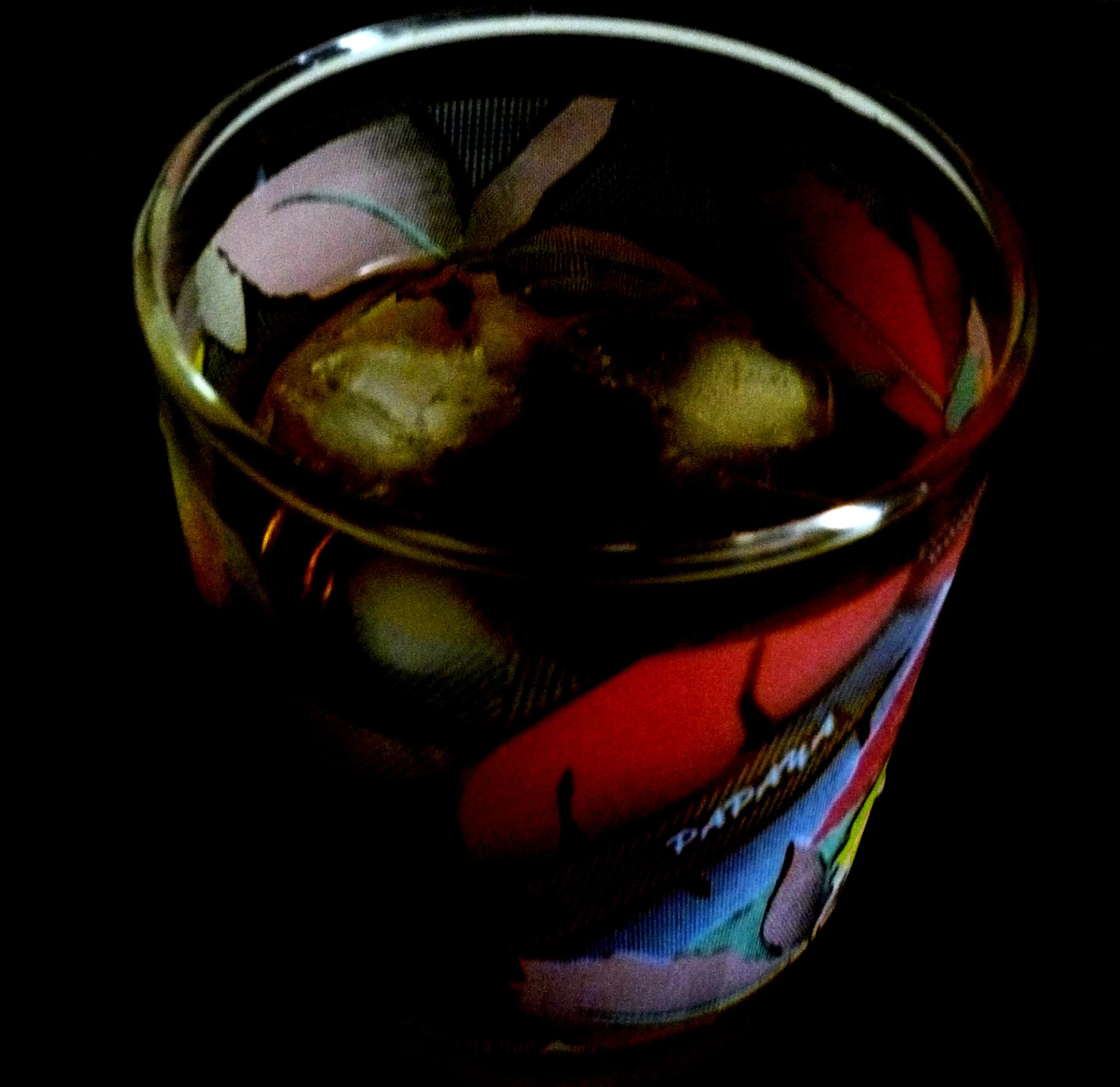 a close up of a glass container containing olives